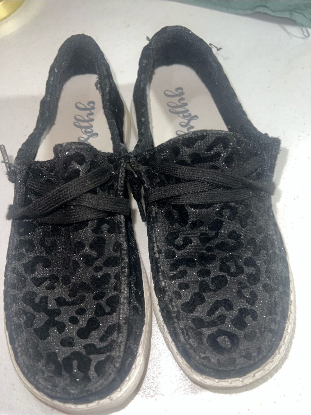 Gypsy Jazz "To the Moon" black leopard print slip-on shoes.